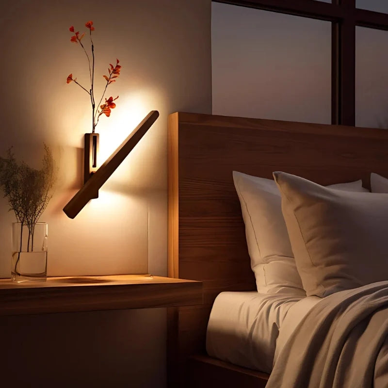 Wood vase wall light lit on a wall