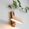 Wood vase wall light used as a handheld
