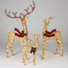 Light up reindeer family set of 3 glowing on a front lawn at Christmas