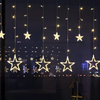 Star curtain lights glowing warm white in a Christmas window