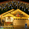 Outdoor curtain lights hanging warm white along a house roofline