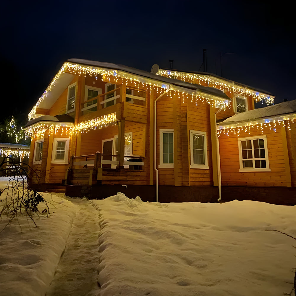 Outdoor curtain lights hanging warm white along a house roofline - photo 2