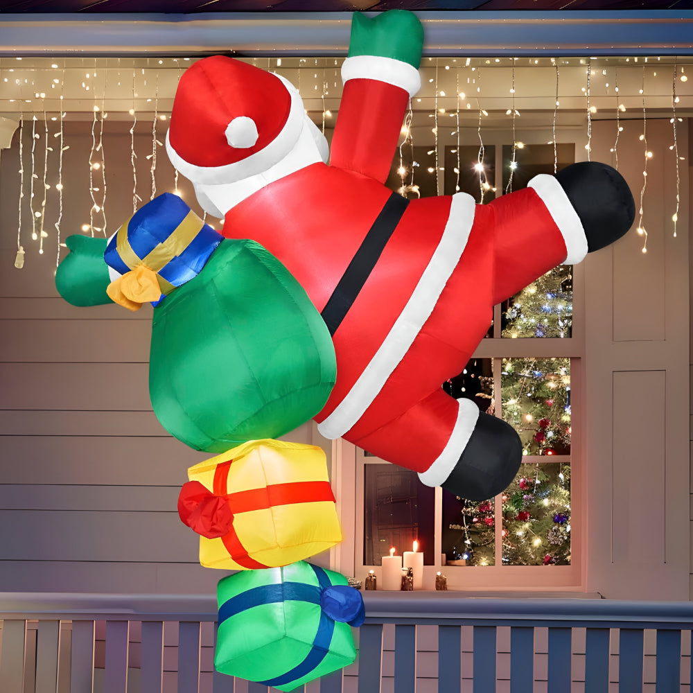 Christmas inflatable climbing Santa lit up on a house at night - photo 2