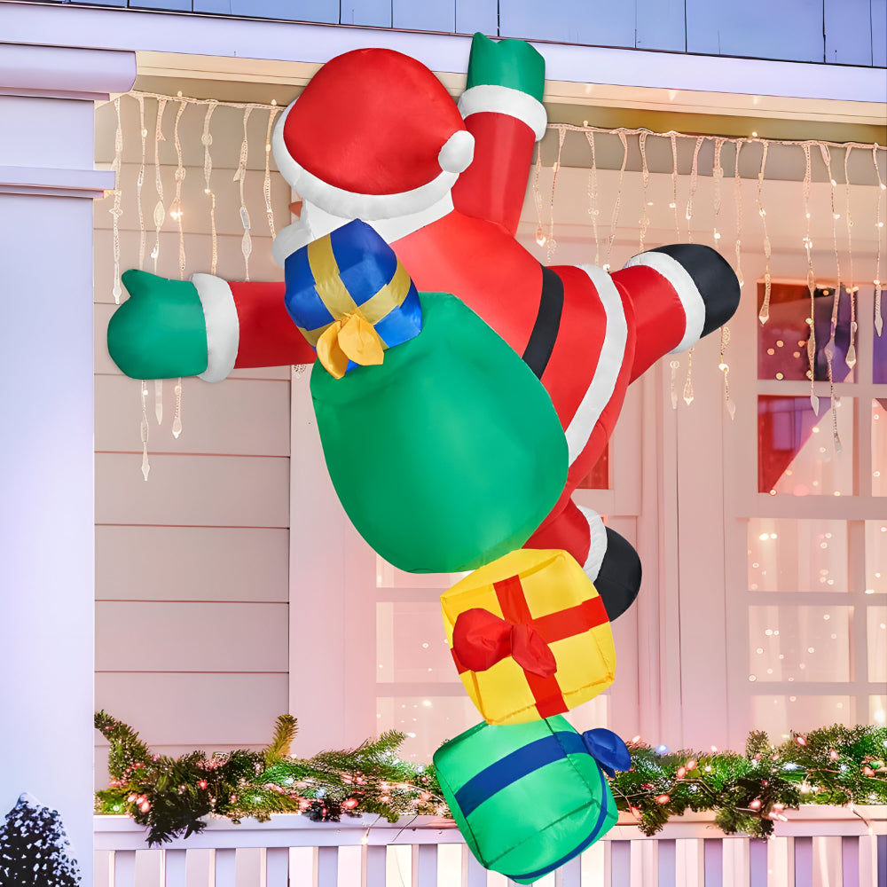 Christmas inflatable climbing Santa lit up on a house at night - photo 3