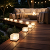 Solar ice cube lights along a deck edge at night
