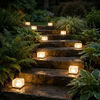 Solar ice cube lights on outdoor garden steps at night