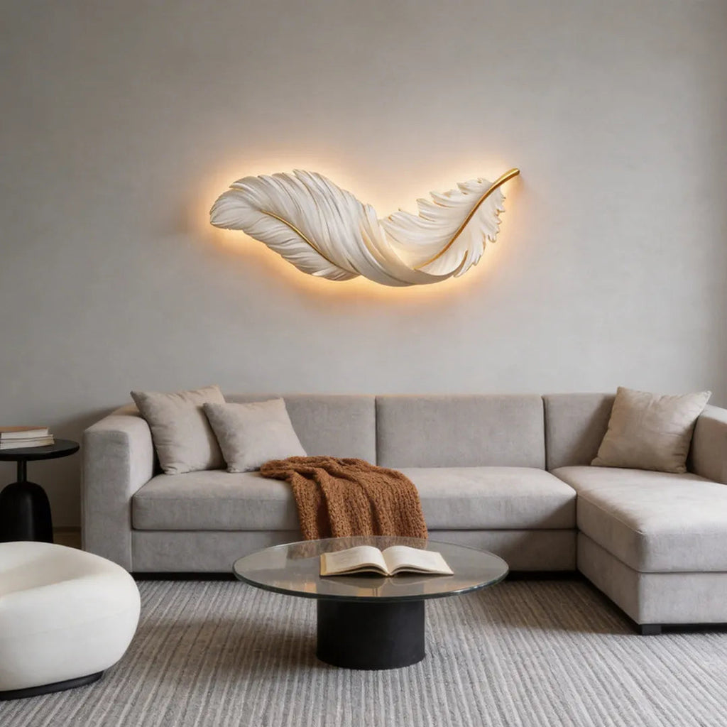 LED wall art feather wall light, warm glow above a sectional sofa