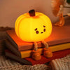Rechargeable pumpkin night light on a stack of books