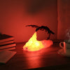 Dragon night light glowing orange on a desk