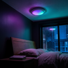 Rechargeable ceiling light in RGB colour mode in a dark bedroom, rain on the window behind