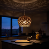 Rattan pendant light Type A lit above a kitchen island at blue hour