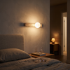 Travertine up and down wall sconce Type A mounted above a bedroom headboard