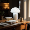 White stone-texture dome table lamp lit neutral 4500K on a writing desk at golden hour