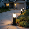 A run of 23.6 inch square solar post lights along a driveway at blue hour