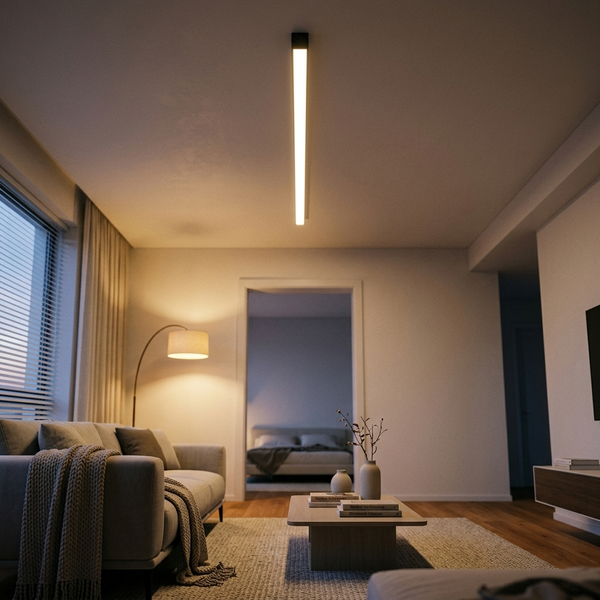 Slim black linear LED ceiling light glowing warm in a modern living room