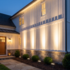 Row of warm white LED wall washer flood lights grazing a farmhouse facade