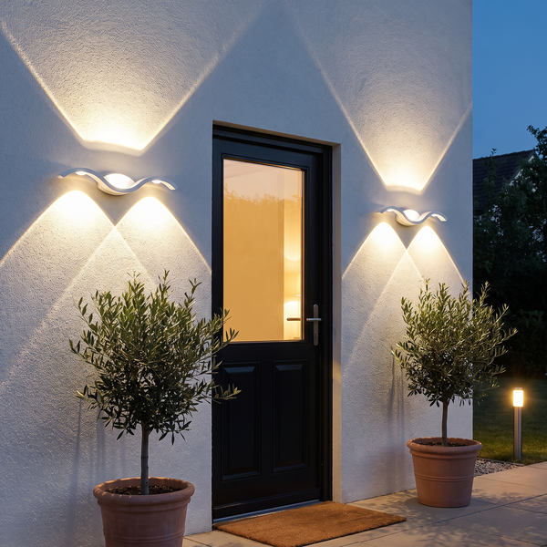Set of 2 white up down LED wall sconces flanking a front door at dusk