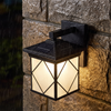 Solar wall sconce with frosted glass staying bright in night rain