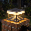 Solar pillar post cap light shedding rain on a brick gate pillar at night