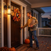 Man arriving home at dusk under the vintage glass porch lantern