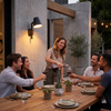Friends at an evening patio dinner under the black cone wall sconce