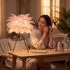 Woman at her vanity in the evening beside the feather tripod lamp