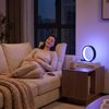 Woman unwinding at night beside the RGB ring lamp's calm violet glow