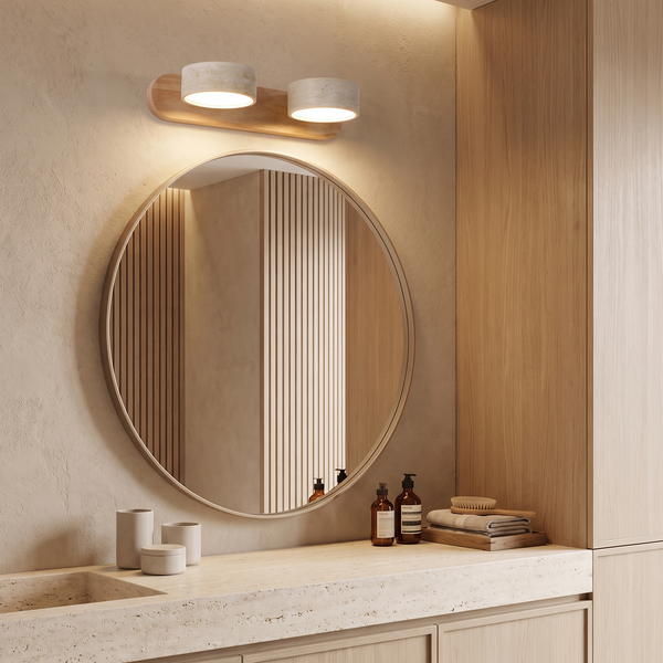 Travertine and wood vanity light above a round mirror in a japandi bathroom