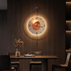 Round LED night light wall clock glowing on a dark wood dining room wall