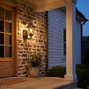 Antique bronze vintage lantern wall sconce at true scale on a stone porch wall