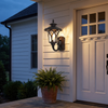 Black vintage lantern wall sconce at true scale beside a farmhouse door