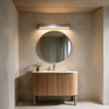 15.7 inch silver vanity bar light in warm white above a round mirror and oak vanity