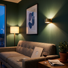 Half cylinder wall light above a sofa on a green wall