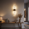 Linear vertical LED wall sconce above a console table