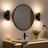 Pair of two-tone up down wall sconces beside a bathroom mirror