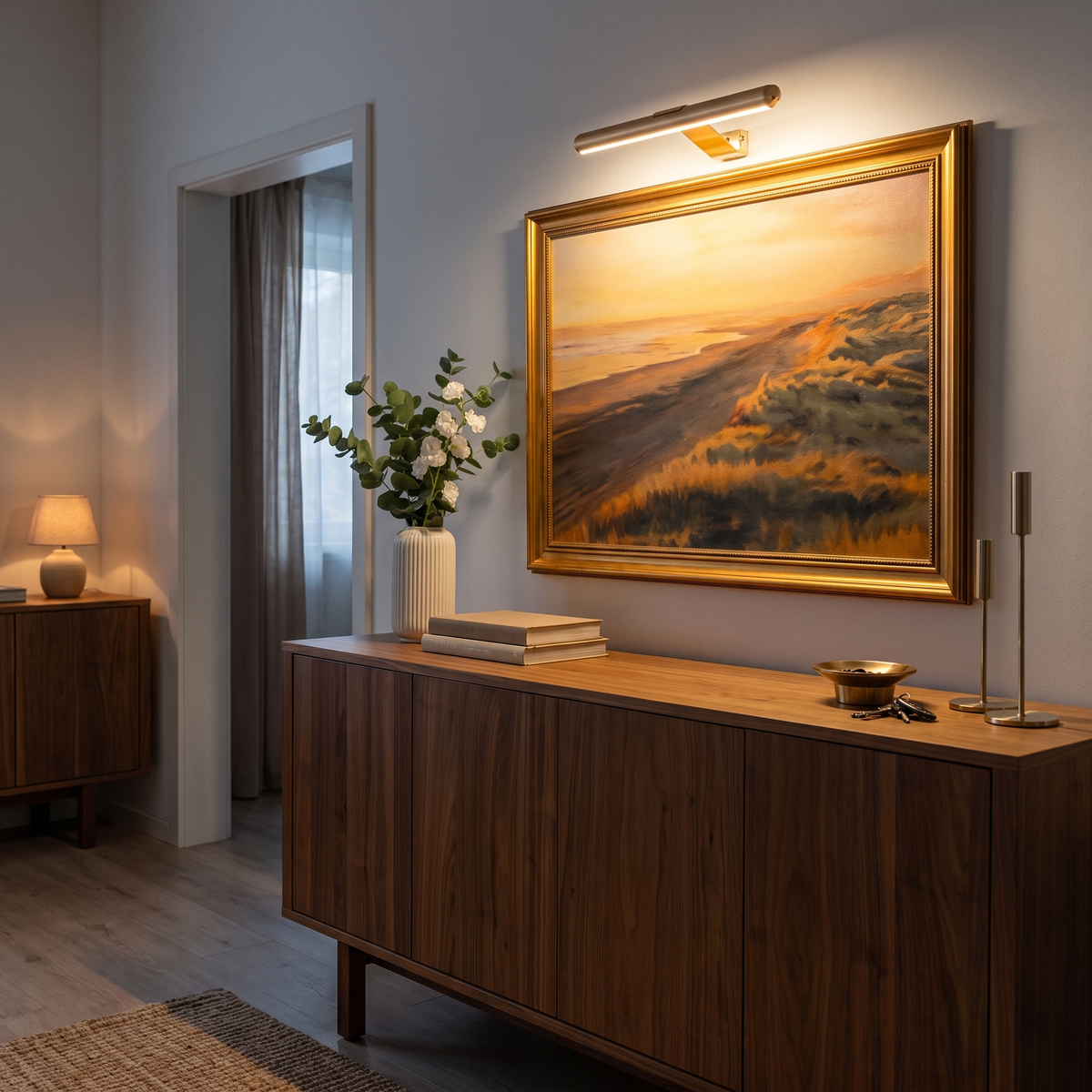 Cordless picture light lighting a framed painting above a sideboard