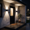Pair of cube wall lights either side of a front door in the rain