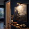 Cordless picture light above a framed painting