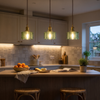 Three glass jar pendants over a kitchen peninsula