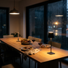 Cordless table lamp on a dining table on a rainy night