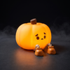 Rechargeable pumpkin night light glowing orange on a dark surface