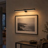 Black 16 inch cordless picture light mounted above framed photograph in an entryway