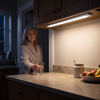 Wireless under cabinet light bar lighting a kitchen counter at night