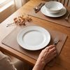 Light coffee leather placemats with dinner plates on a wooden table