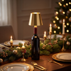 Wine bottle light, gold shade, on a Christmas dinner table