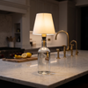 Cordless bottle lamp, white shade, on a marble kitchen island