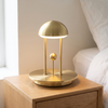 Balance lamp, gold, cordless magnetic ball switch table lamp on a nightstand