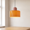 Bauhaus plug in pendant light, orange glass, over a dining table