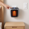 Compact Space Heater Plugged Into Wall Outlet, Hand Size Comparison