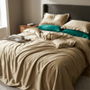 Silk bedding set on an unmade bed, Champagne